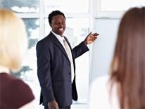 Workshop and Training Man standing by easel in front of audience